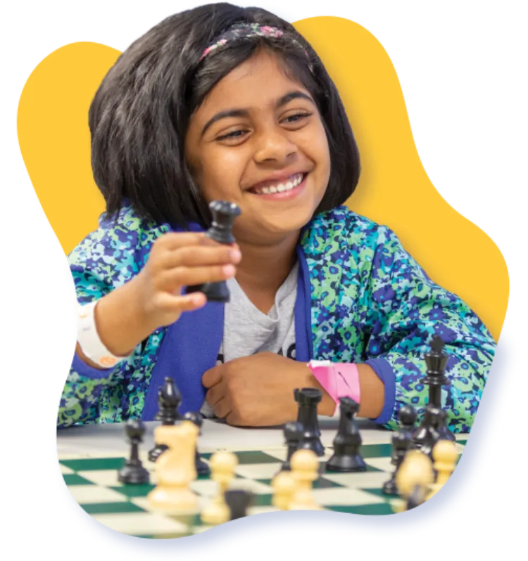 smiling girl playing chess